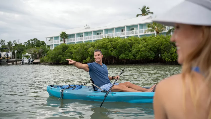 Man in kayak pointing out to the distance